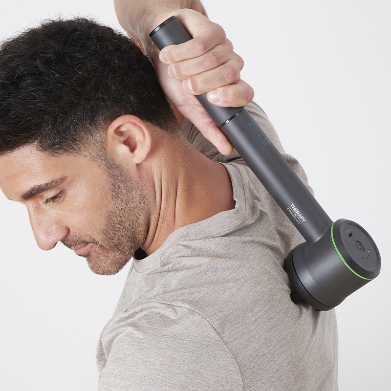 Man using massager on back